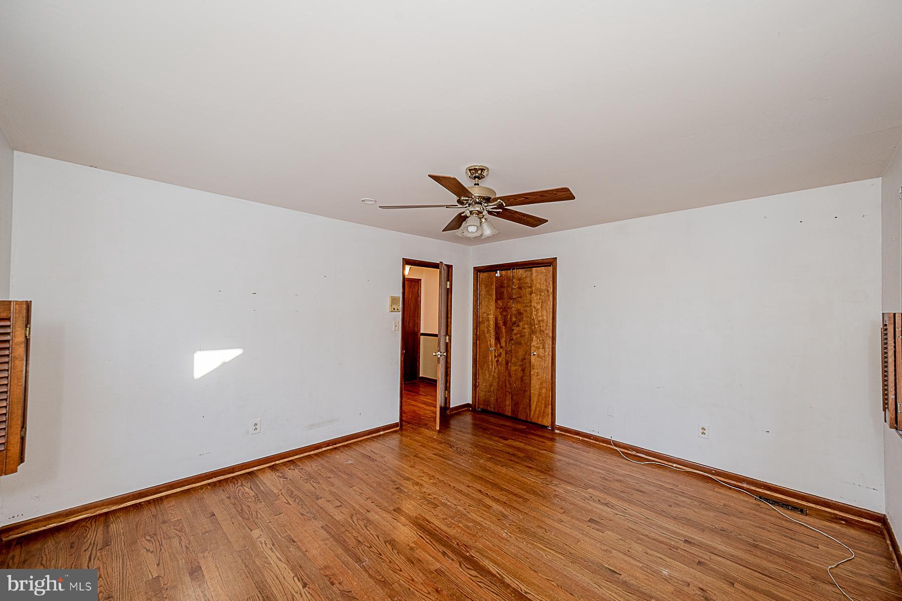 12008 Mettee Road Marriottsville, MD 21104 - Photo 22 of 36 a view of a room with wooden floor and ceiling fan
