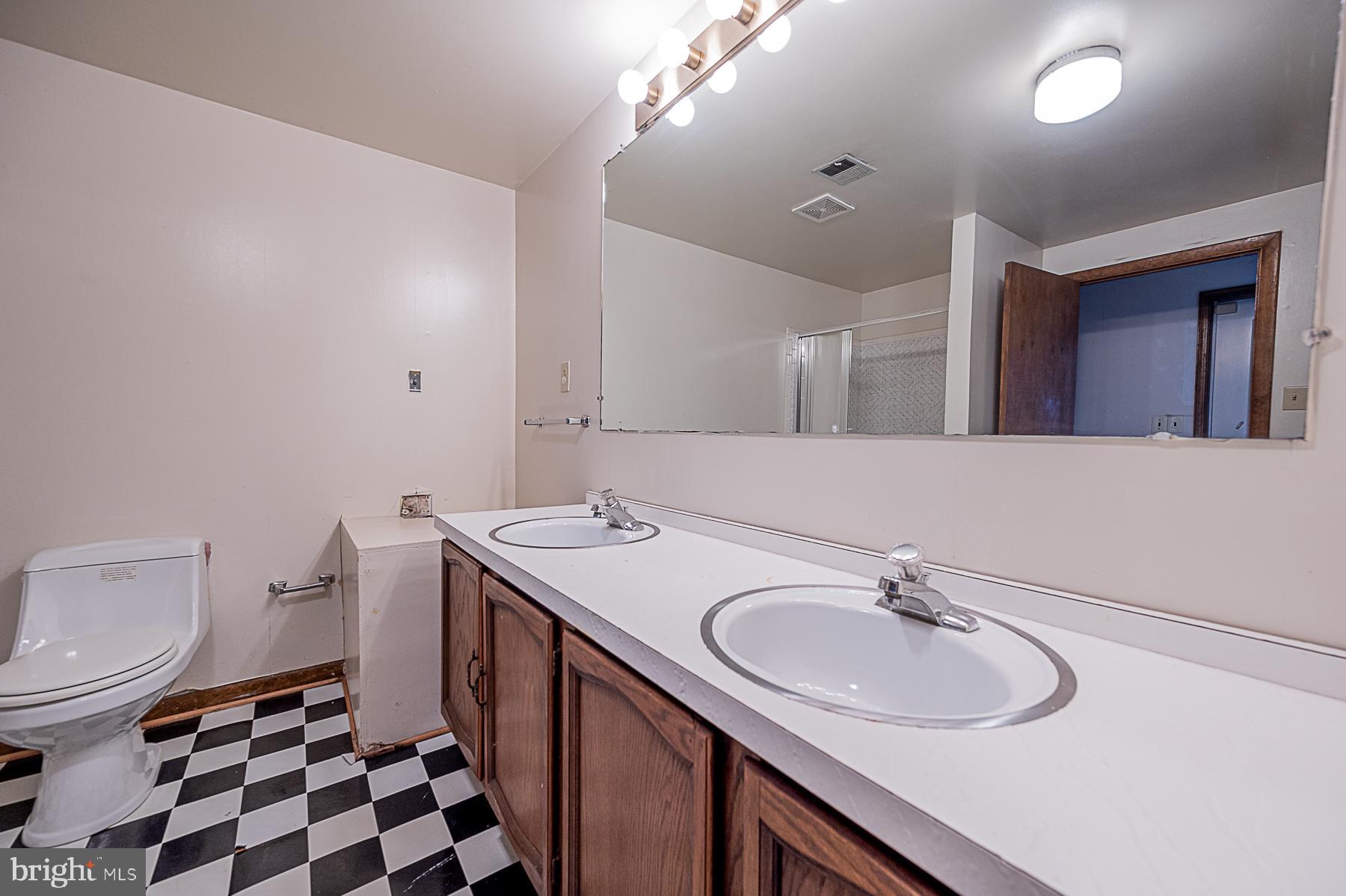 12008 Mettee Road Marriottsville, MD 21104 - Photo 27 of 36 a bathroom with a sink a toilet a mirror and shower