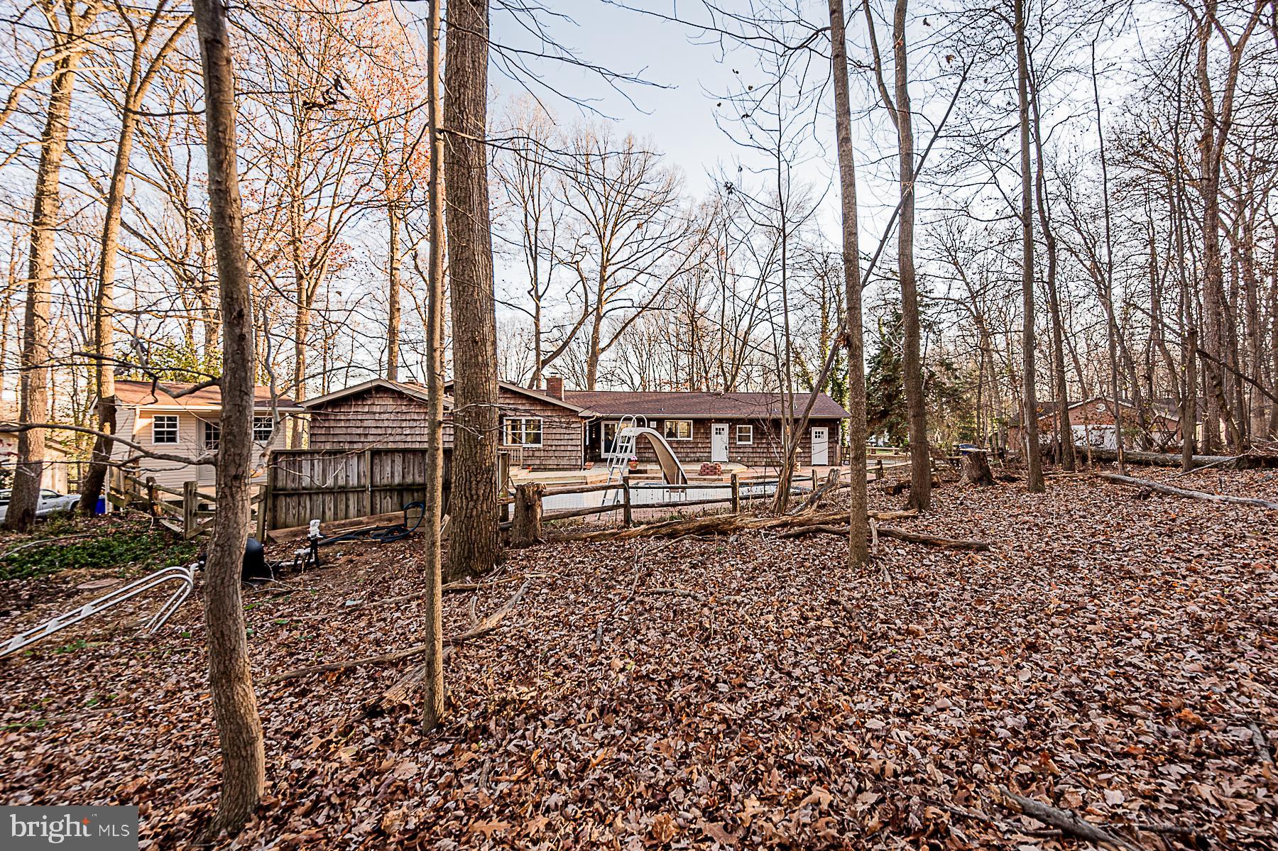 12008 Mettee Road Marriottsville, MD 21104 - Photo 35 of 36 front view of a house with a bench