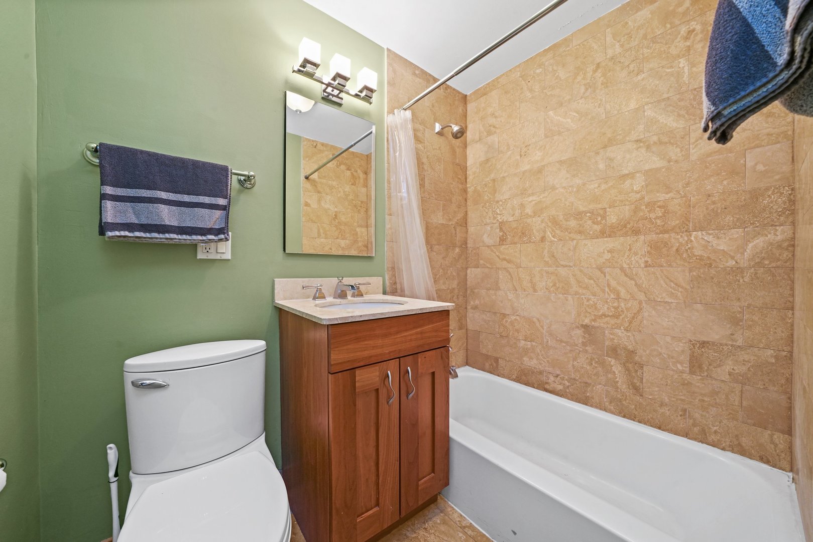 2930 North Sheridan Road, Unit 805 Chicago, IL 60657 - Photo 14 of 21 a bathroom with a granite countertop toilet a sink and a bathtub