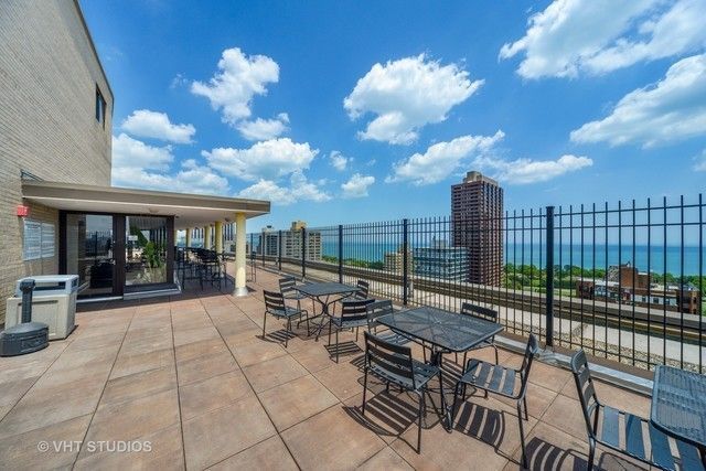 2930 North Sheridan Road, Unit 805 Chicago, IL 60657 - Photo 15 of 21 a view of a patio with a dining table and chairs with wooden floor