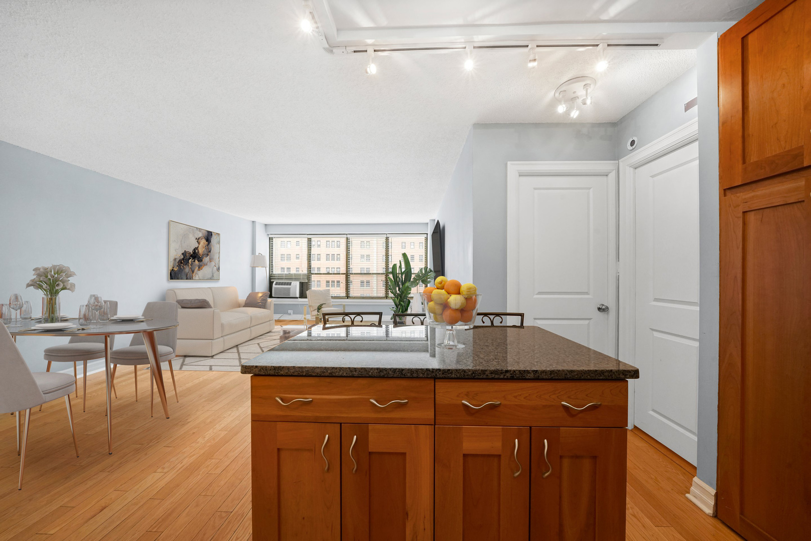 2930 North Sheridan Road, Unit 805 Chicago, IL 60657 - Photo 5 of 21 a dining table with chairs and wooden floor