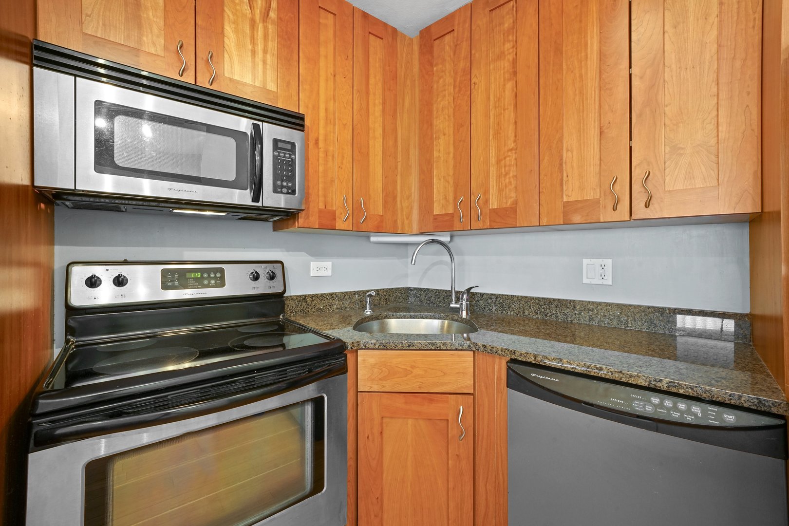 2930 North Sheridan Road, Unit 805 Chicago, IL 60657 - Photo 7 of 21 a kitchen with a stove microwave and sink