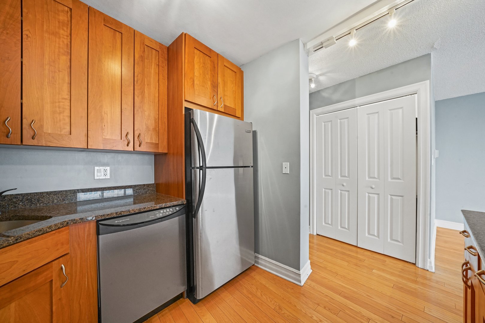 2930 North Sheridan Road, Unit 805 Chicago, IL 60657 - Photo 10 of 21 a kitchen with a refrigerator and cabinets