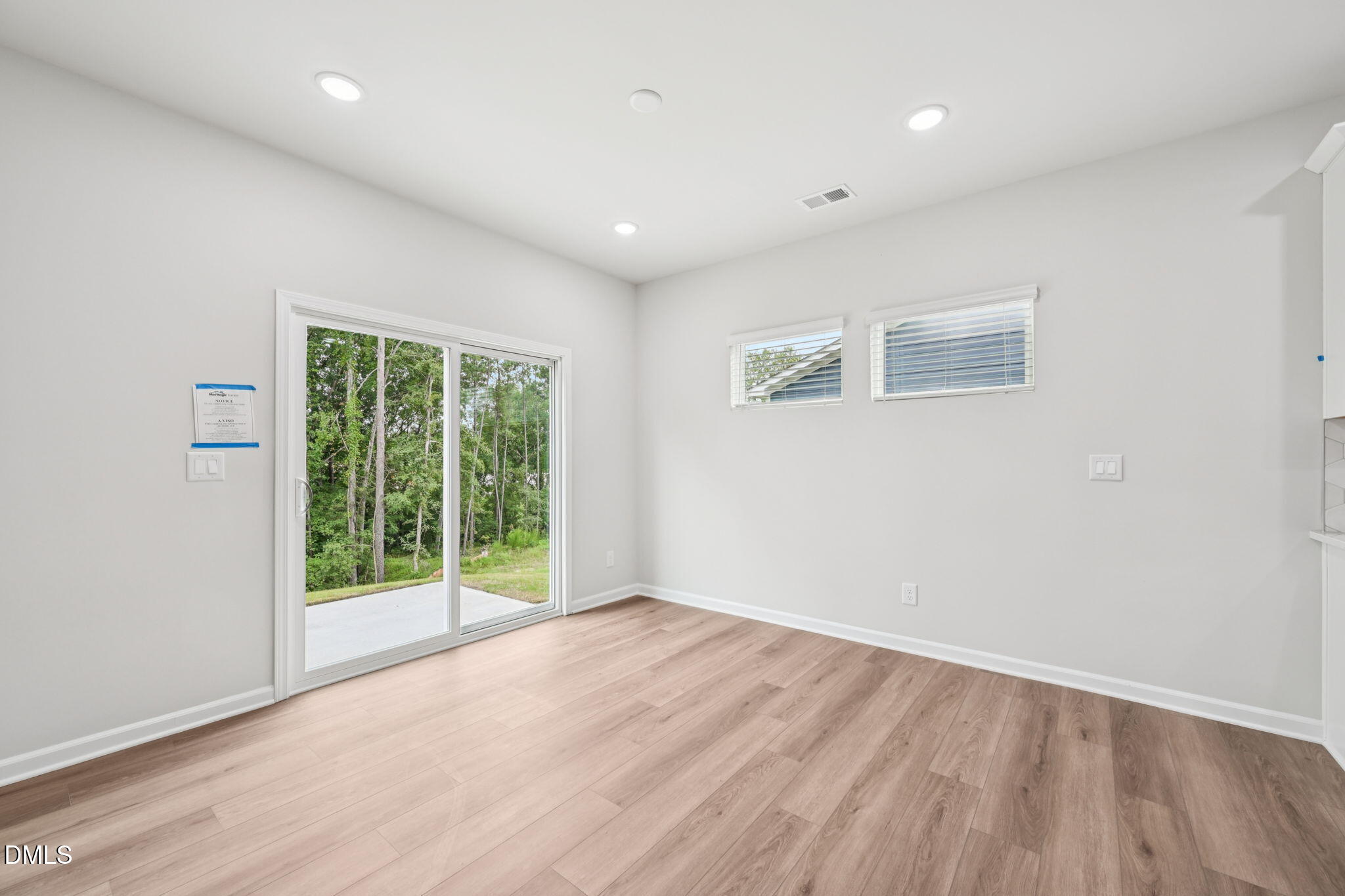 2145 Topsail Road Durham, NC 27703 - Photo 15 of 53 a view of an empty room with wooden floor and a window