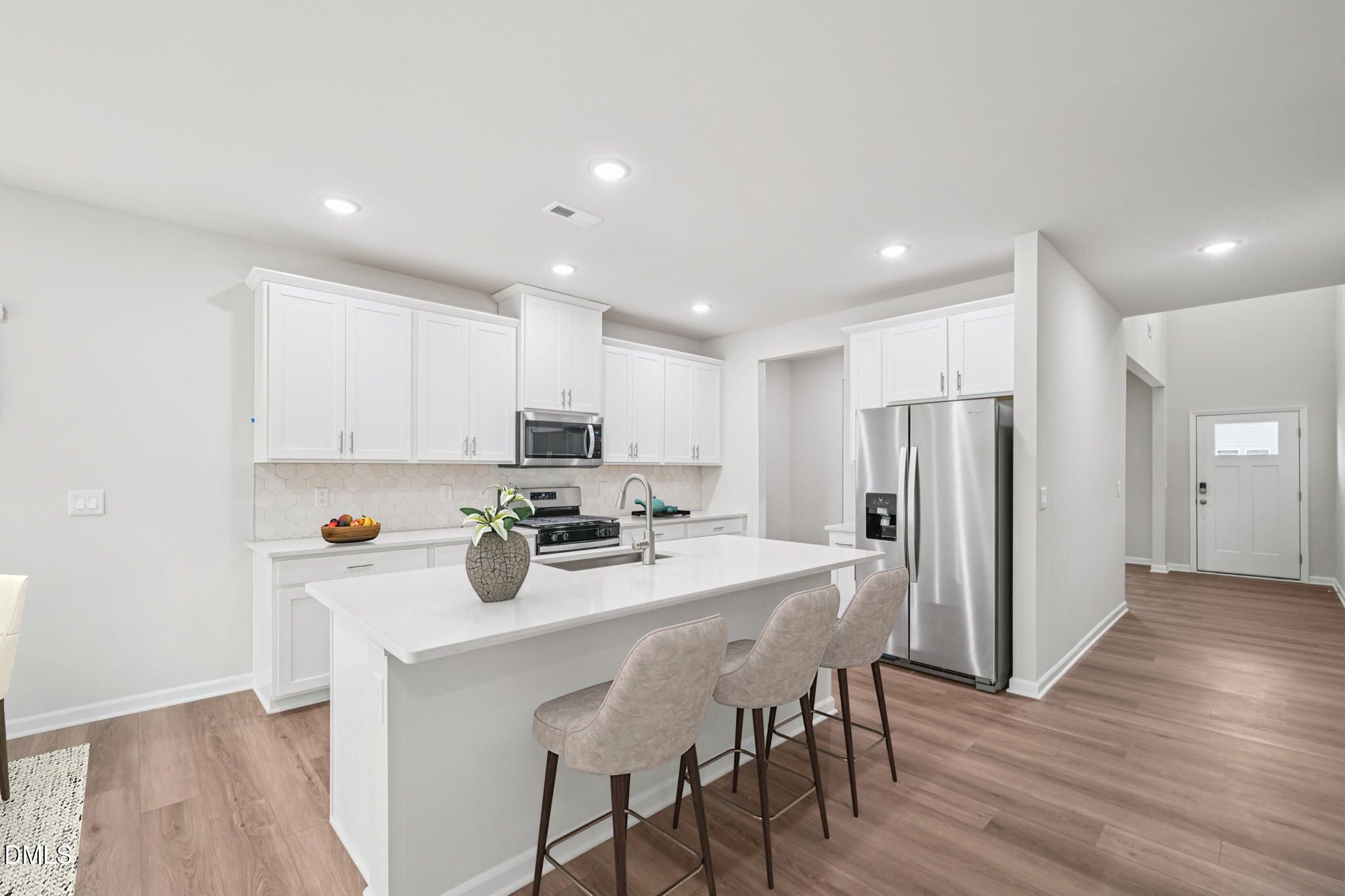 2145 Topsail Road Durham, NC 27703 - Photo 16 of 53 a kitchen with stainless steel appliances a dining table chairs and wooden floor
