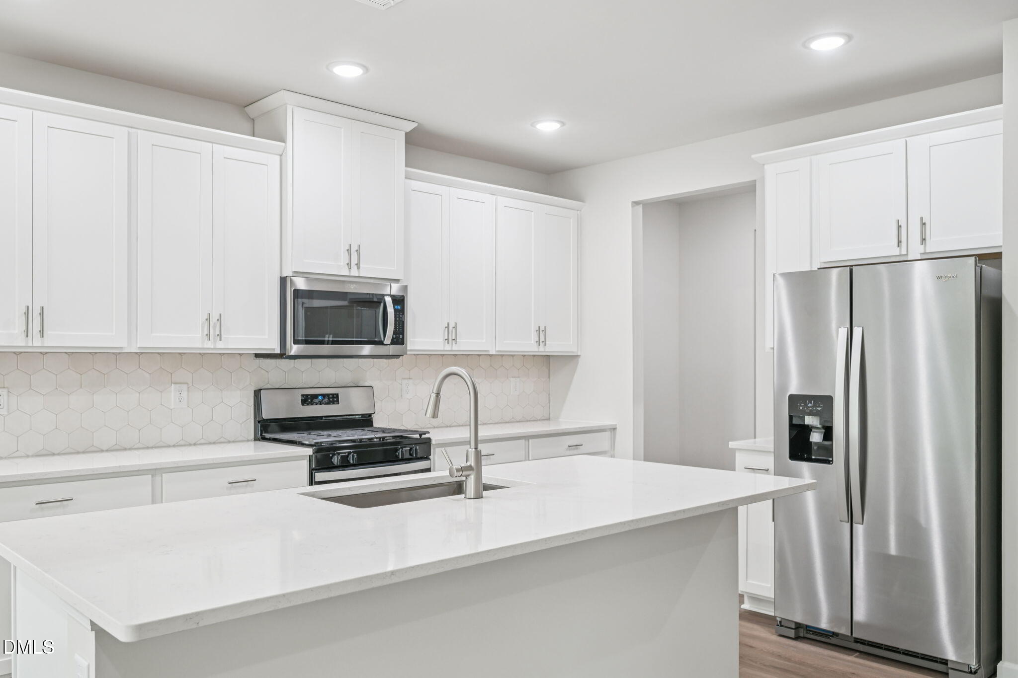 2145 Topsail Road Durham, NC 27703 - Photo 19 of 53 a kitchen with stainless steel appliances a refrigerator sink and white cabinets