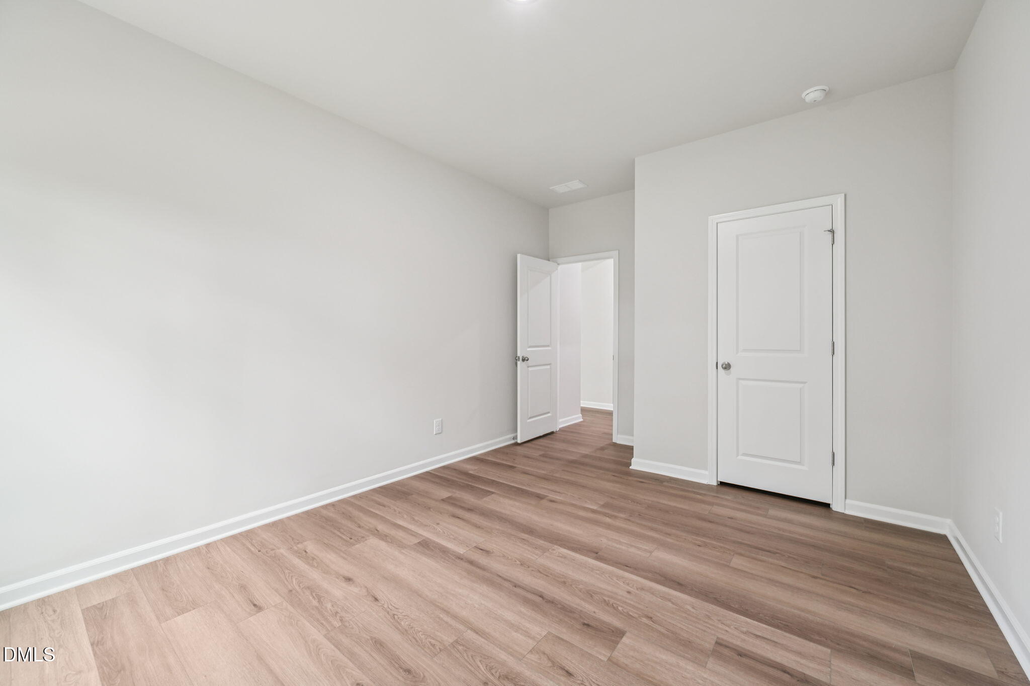 2145 Topsail Road Durham, NC 27703 - Photo 28 of 53 a view of an empty room with wooden floor