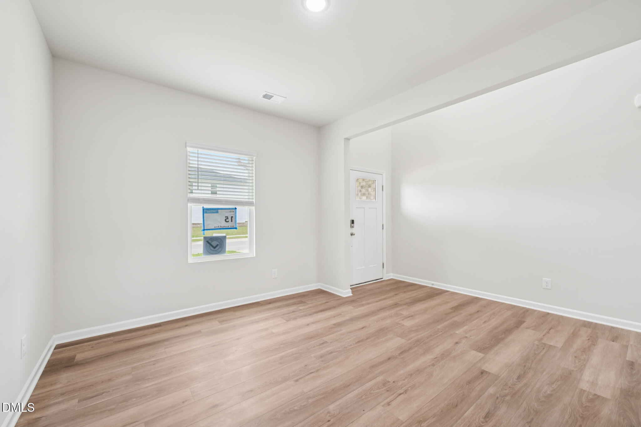 2145 Topsail Road Durham, NC 27703 - Photo 7 of 53 an empty room with wooden floor and windows