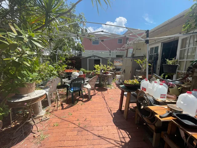 a view of a patio with dining table and chairs under an umbrella