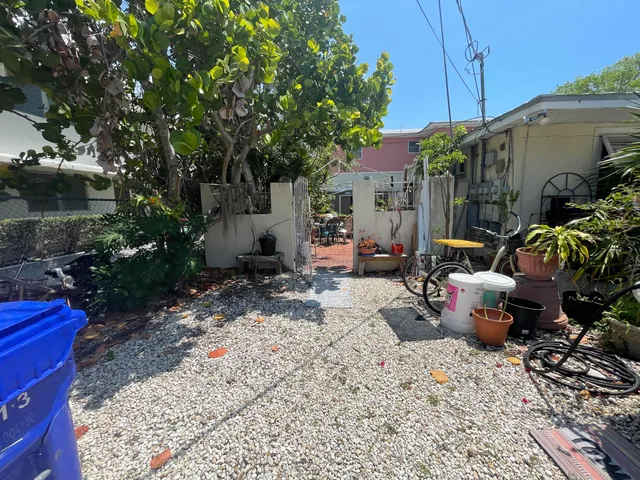 a view of a backyard with plants and a patio