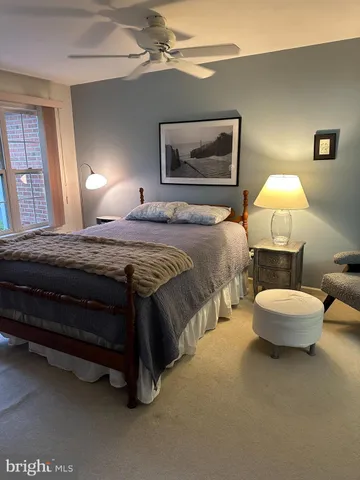 a bedroom with a bed and a lamp