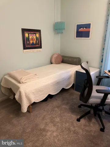 a bedroom with a bed and a desk