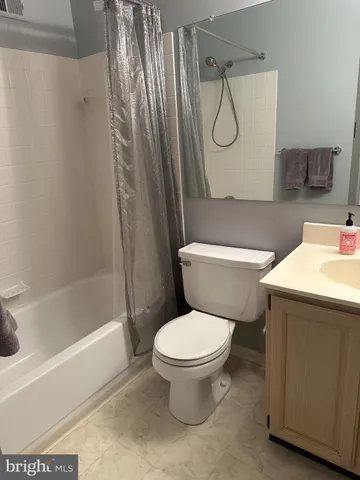 a white toilet sitting next to a shower