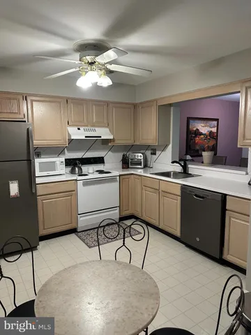 a kitchen with a sink cabinets and stainless steel appliances