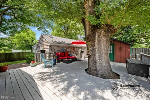 a backyard of a house with outdoor seating