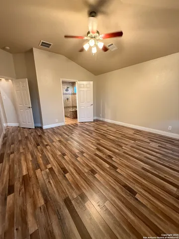 a view of a livingroom with a ceiling fan and window