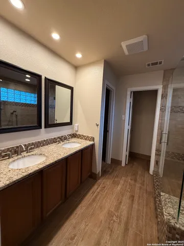 a view of a kitchen with a sink and a refrigerator