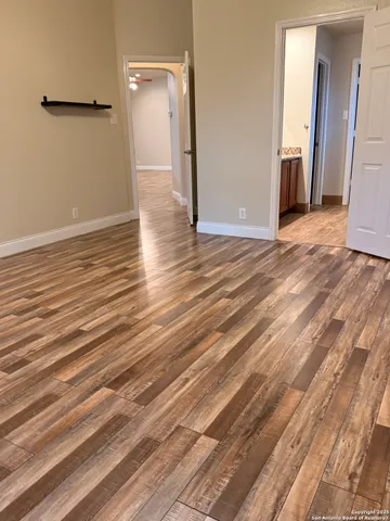 a view of a room with wooden floor