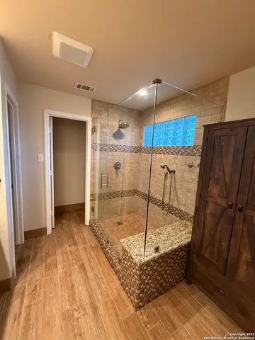 a view of a bedroom with wooden floor