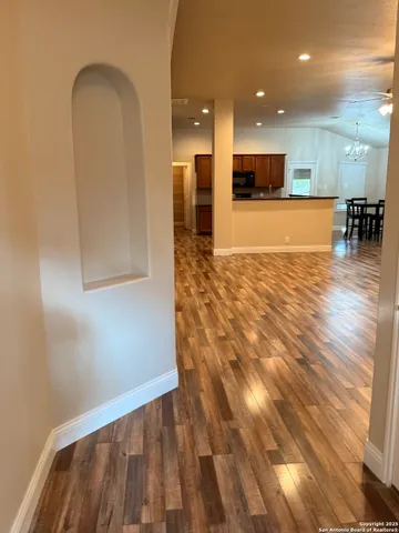 a view of a room with wooden floor and a window