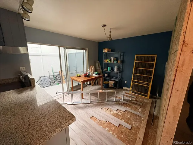 a living room with furniture a rug and a floor to ceiling window