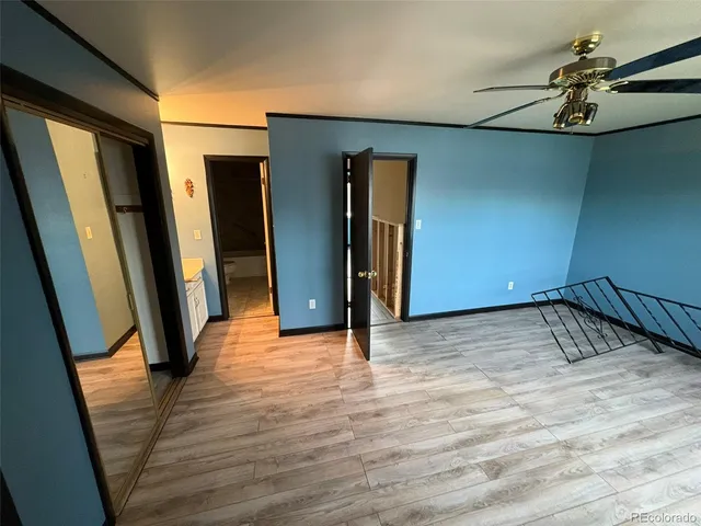 a view of a room with wooden floor