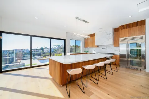 a large dining space with furniture window and wooden floor