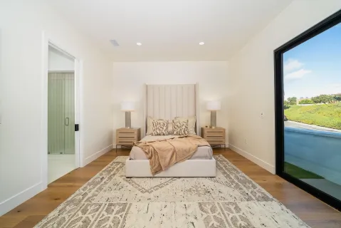 a bedroom with a bed and a window