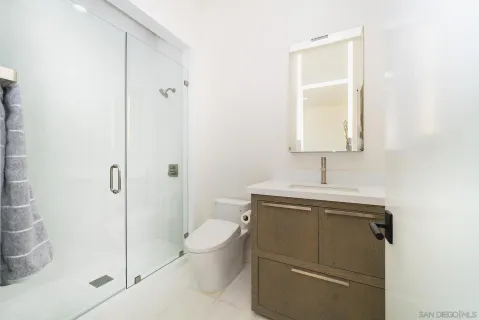 a spacious bedroom with a large bed and a large window