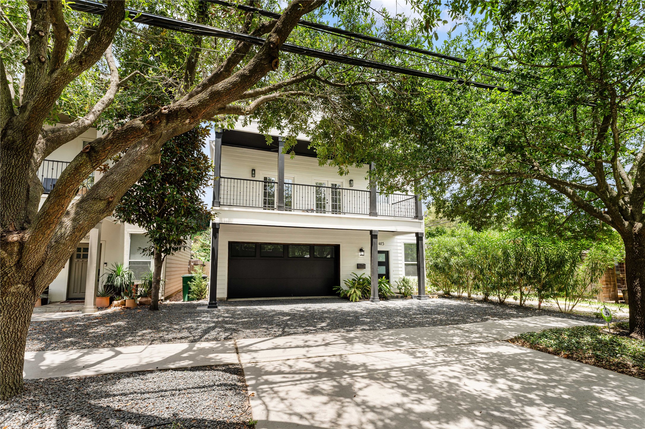 415 West 8th Street Houston, TX 77007 - Photo 38 of 39 The clean, contemporary exterior is highlighted by contrasting black columns and garage door, expansive covered balcony, and lush mature landscaping, creating a sophisticated look that stands out while fitting perfectly into the neighborhood. Modern Heights living in this beautifully updated 3-bedroom, 2-bath, two-story home just one block from the Heights Hike & Bike Trail and less than 5 miles from Downtown Houston.