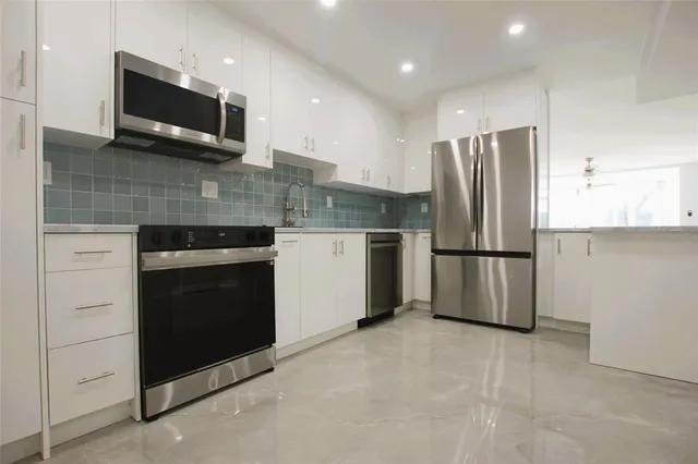 a kitchen with a refrigerator stove and microwave