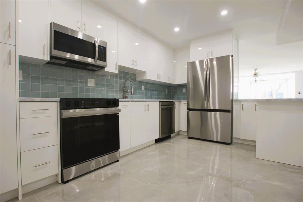 a kitchen with a refrigerator stove and microwave