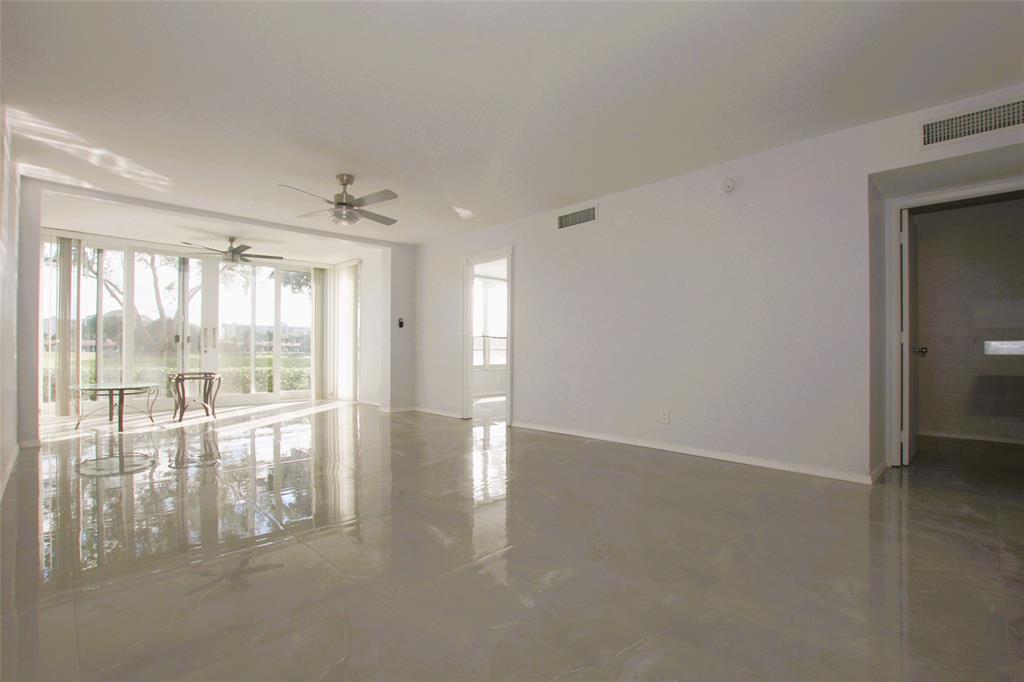 3100 North Course Lane, Unit 103 Pompano Beach, FL 33069 - Photo 18 of 51 a view of an empty room with a window