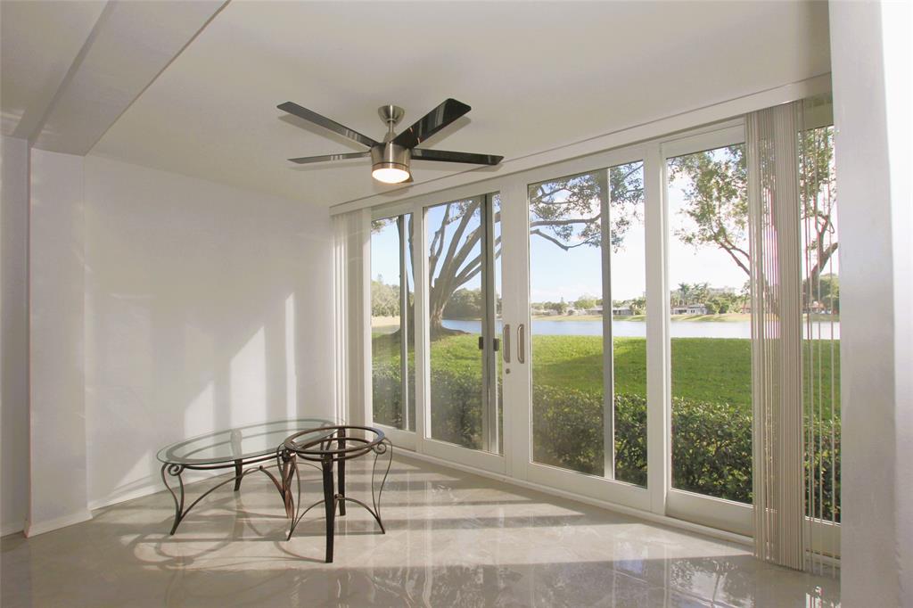 3100 North Course Lane, Unit 103 Pompano Beach, FL 33069 - Photo 20 of 51 a view of a livingroom with furniture window and outside view