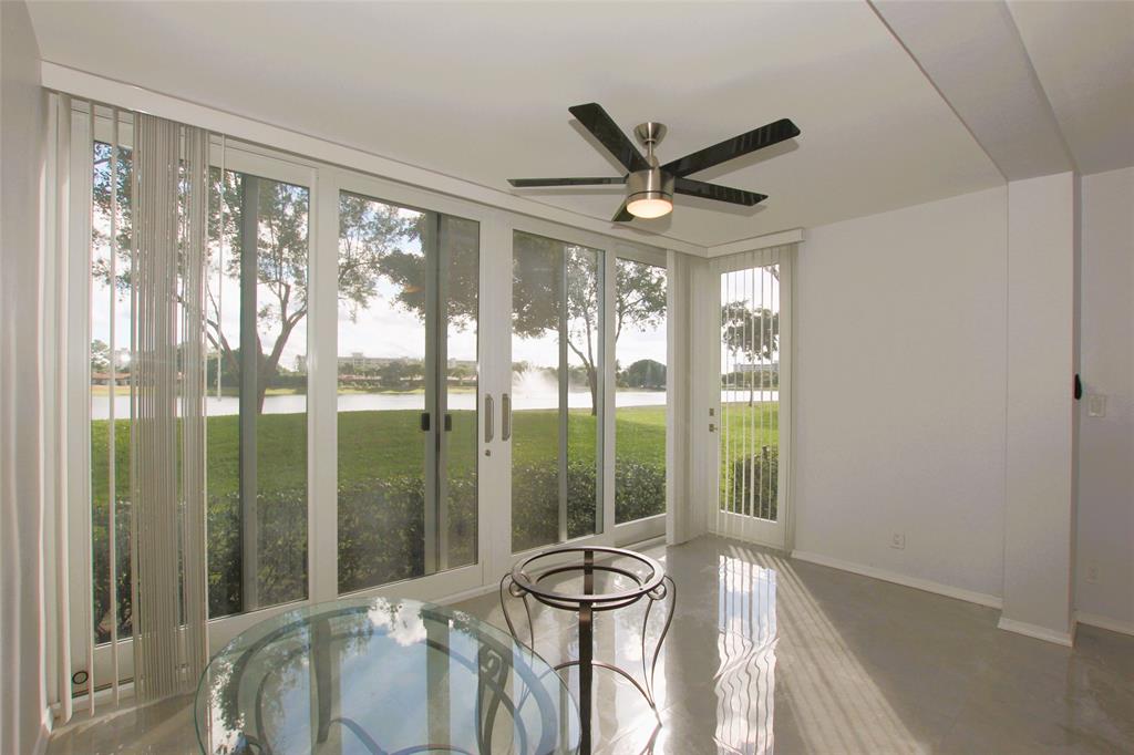 3100 North Course Lane, Unit 103 Pompano Beach, FL 33069 - Photo 21 of 51 a living room with furniture and a large window