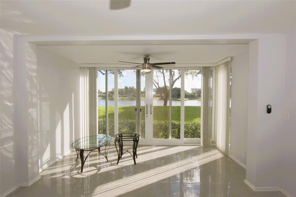 3100 North Course Lane, Unit 103 Pompano Beach, FL 33069 - Photo 22 of 51 a view of a room that has a bed and large window