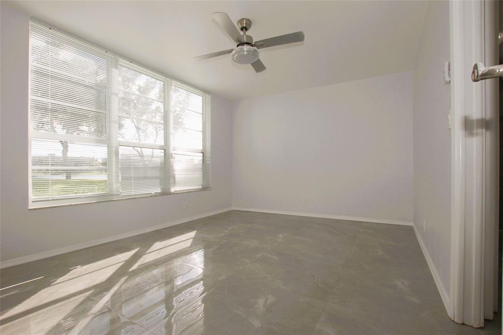 3100 North Course Lane, Unit 103 Pompano Beach, FL 33069 - Photo 26 of 51 a view of an empty room with a window