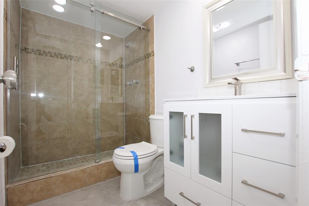 3100 North Course Lane, Unit 103 Pompano Beach, FL 33069 - Photo 28 of 51 a bathroom with a shower and a toilet