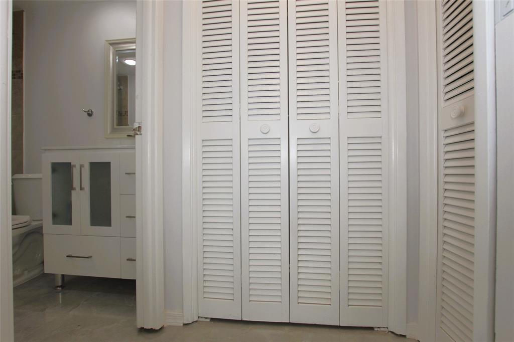 3100 North Course Lane, Unit 103 Pompano Beach, FL 33069 - Photo 29 of 51 a view of a bathroom with a white door