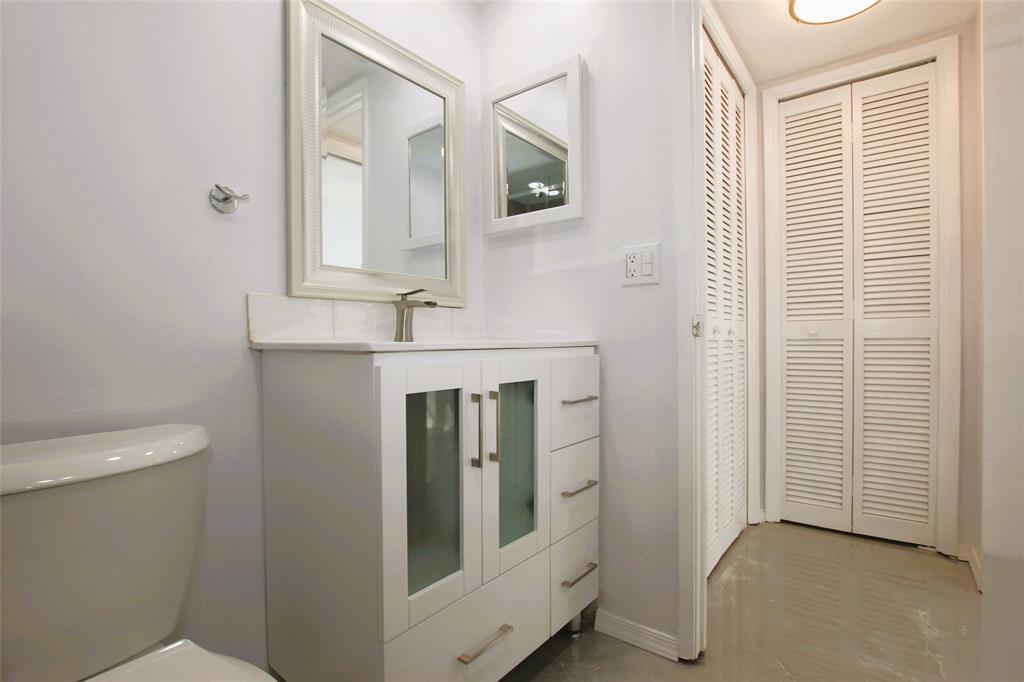 3100 North Course Lane, Unit 103 Pompano Beach, FL 33069 - Photo 30 of 51 a bathroom with a sink and a mirror