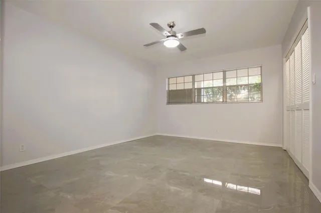 an empty room with a empty space and a ceiling fan
