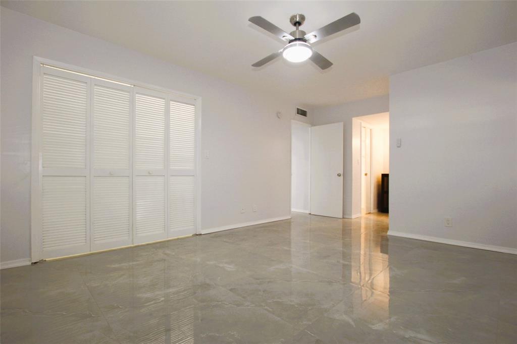 3100 North Course Lane, Unit 103 Pompano Beach, FL 33069 - Photo 36 of 51 wooden floor in an empty room with a window