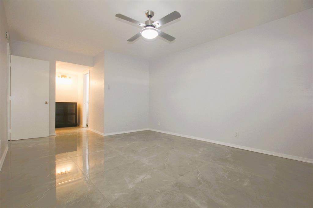 3100 North Course Lane, Unit 103 Pompano Beach, FL 33069 - Photo 37 of 51 an empty room with a empty space and a ceiling fan