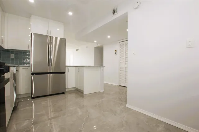 a kitchen with stainless steel appliances granite countertop a sink and a microwave