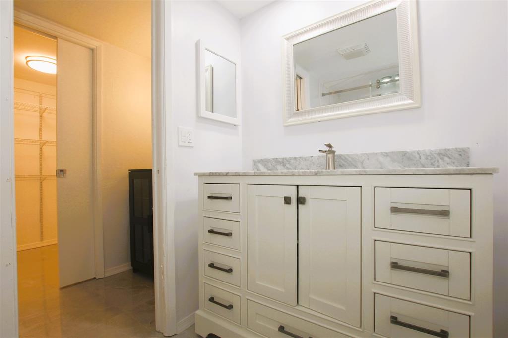 3100 North Course Lane, Unit 103 Pompano Beach, FL 33069 - Photo 41 of 51 a bathroom with a granite countertop sink and a mirror