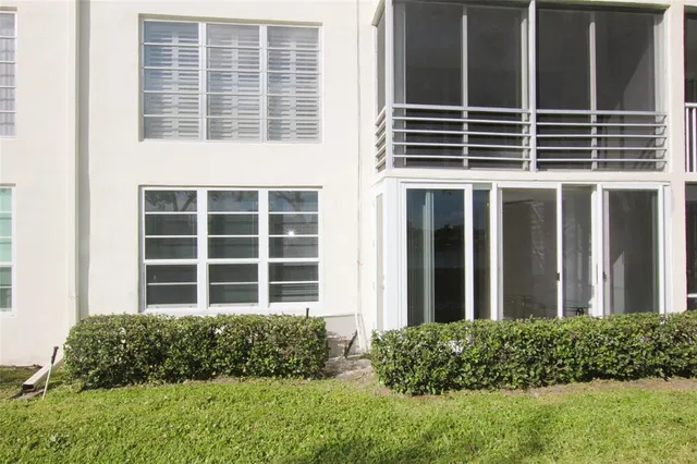 a front view of a building with a yard