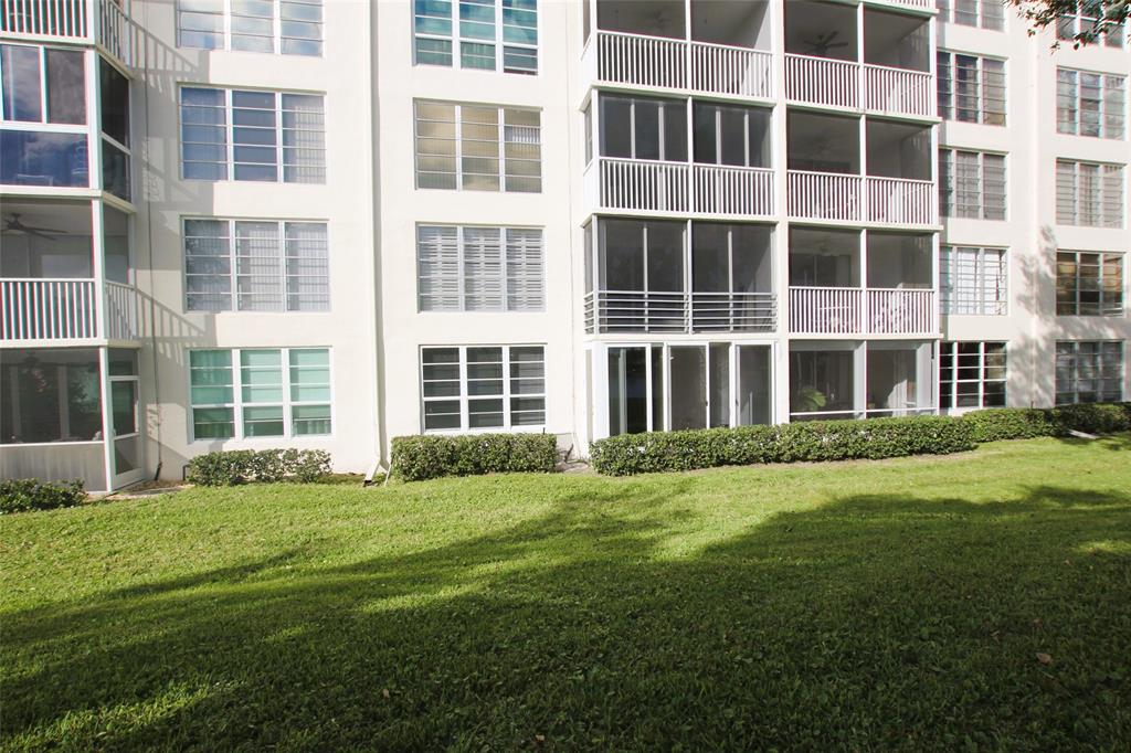3100 North Course Lane, Unit 103 Pompano Beach, FL 33069 - Photo 46 of 51 a view of a building with a yard