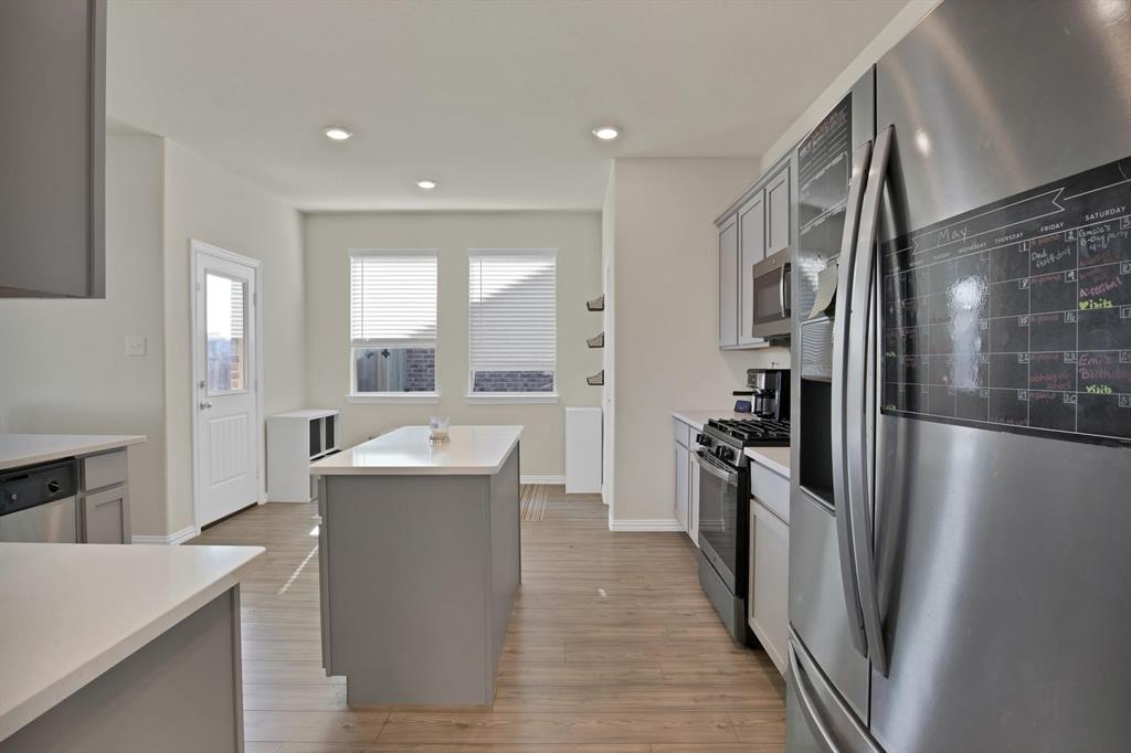 621 Ridgeback Trail Fort Worth, TX 76052 - Photo 5 of 22 Kitchen featuring wood-finish flooring, recessed lighting, and a center island with a light-colored countertop