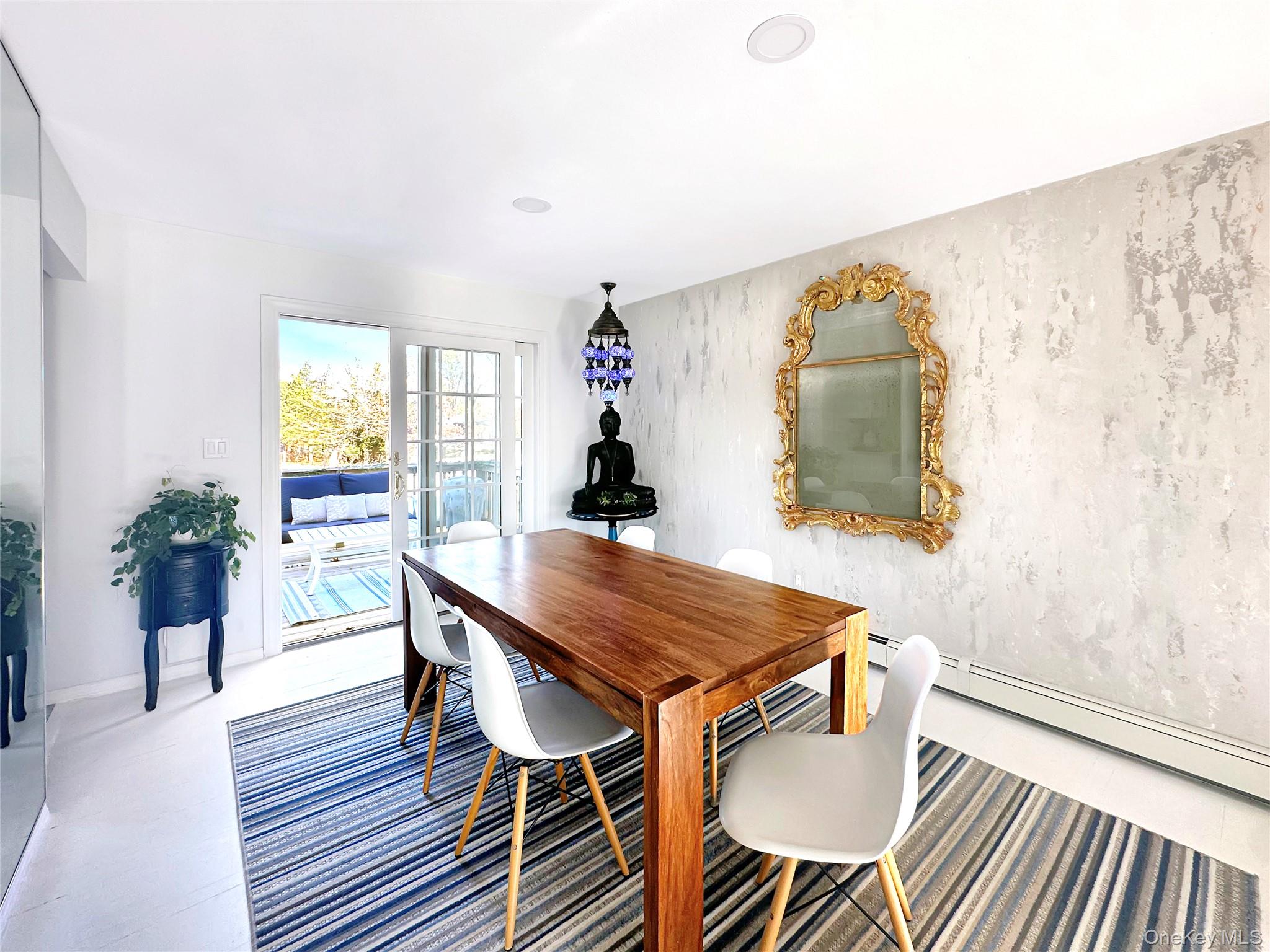8 Westerly Court Hampton Bays, NY 11946 - Photo 11 of 26 a dining room with furniture and wooden floor